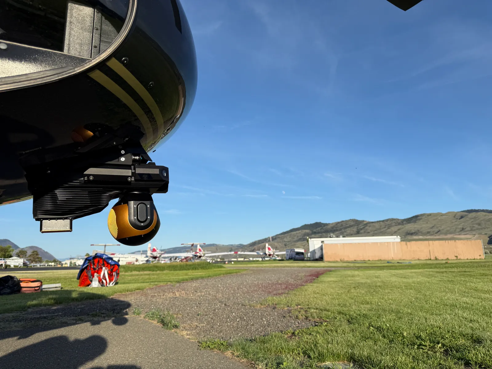 VoxVision installed beneath an AS350 helicopter at an airfield.